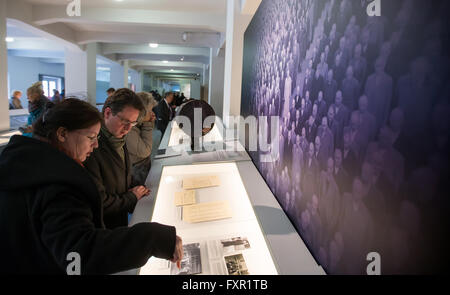 Weimar, Germany. 17th Apr, 2016. Visitors look at exhibits in the overhauled permanent exhibition 'Buchenwald 1937-1945' at the former central building of Buchenwald concentration camp in Weimar, Germany, 17 April 2016. The permanent exhibition which was reopened on the same day spans 2,000 square metres and outlines the history of the concentration camp. Photo: MICHAEL REICHEL/dpa/Alamy Live News Stock Photo