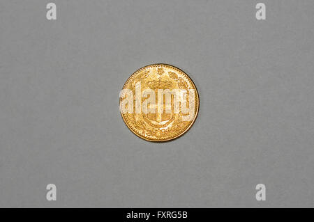 19th century Italian 20 lire gold coin. Reverse side with the coat of arms of the house of Savoia. Stock Photo