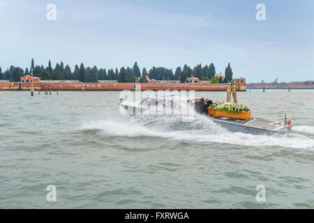 Venice, Italy. Water hearse or funerary, funeral boat on it's way to Venice's cemetery on Isola di San Michele Island. Stock Photo