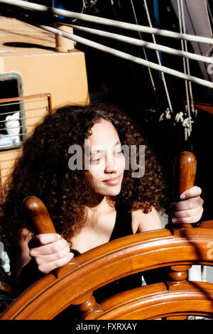 Young Attractive Woman Gripping Spokes Of Steering Wheel Ship Stock Photo