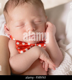 Newborn baby sleeping on sheet Stock Photo