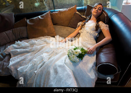 Bride, portrait, resting on a couch Stock Photo