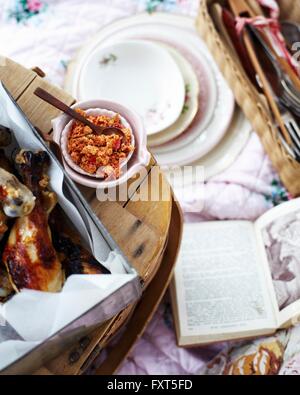 Overhead view of picnic with chicken legs with citrus chilli salt Stock Photo