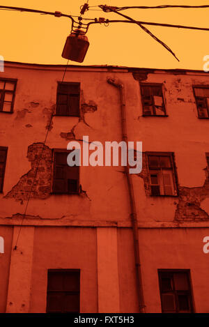 Old abandoned house in Moscow city center (Savinskiy pass). Image is captured with red filter to minimize colours and to define Stock Photo