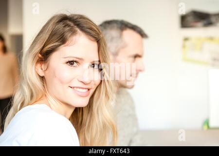 Portrait of young brown eyed woman looking at camera smiling Stock Photo