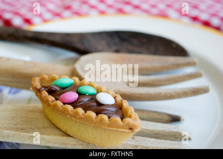 pastry with chocolate cream and colored sugared almonds Stock Photo