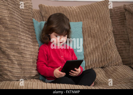 Young girl watch cartoon on Tablet Stock Photo
