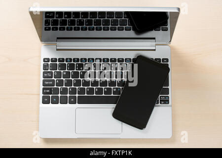 Smart phone on top of small tablet PC Stock Photo