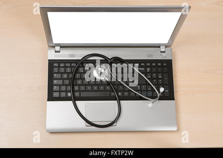 Doctors laptop with stethoscope on keyboard Stock Photo