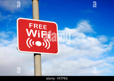 Free wifi sign against a blue sky Stock Photo