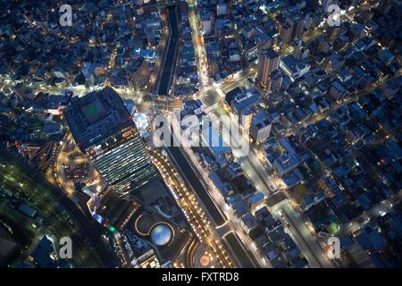 Overhead view of skyscrapers and highways at night, Tokyo, Japan Stock Photo