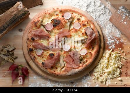 Overhead view of parma ham and radish pizza Stock Photo