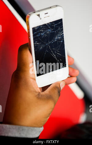 Hackney, London, UK. Client at Restart Party showing her smashed Apple iPhone 4 screen. Stock Photo