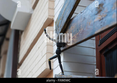 Small metal sculptures of man on window Stock Photo