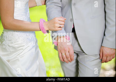 Hands of man and woman bride groom in handcuffs Stock Photo