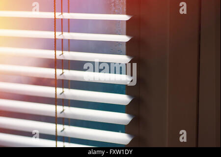 Sunlight coming through venetian blinds by the window Stock Photo