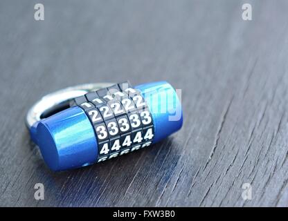 New blue metal combination lock on dark background. Stock Photo