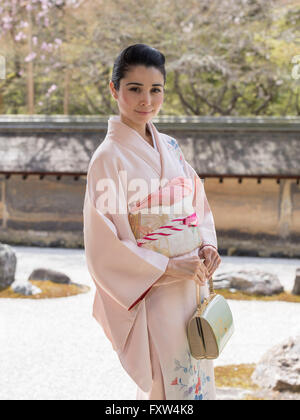 Japanese woman in kimono at Ryoan-ji Zen Temple home to famous stone garden, Kyoto, Japan Stock Photo