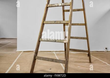 painters ladder standing on a covered floor Stock Photo
