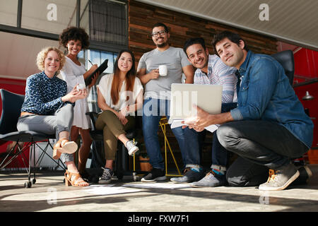 Team of creative professionals meeting in office. Multiracial group of young designers working together for a new project. Stock Photo