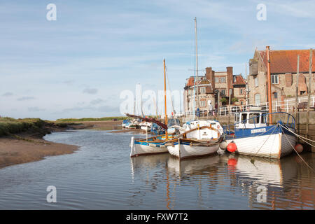 Sailing boats moored at Blakeney Harbour, Blakeney, Norfolk, England with the Blakeney Hotel in the background Stock Photo