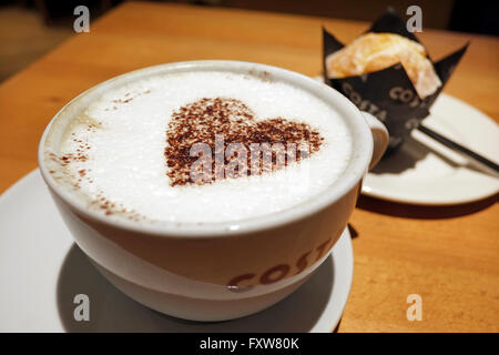 cappuccino coffee and heart shaped chocolate Stock Photo