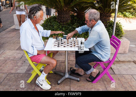 Two men playing chess in a street, Saint Tropez, France Stock Photo