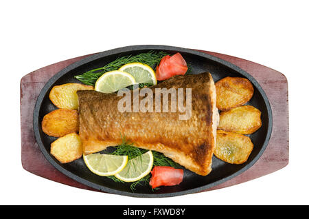 Fried fish in the pan, on a white background. Stock Photo