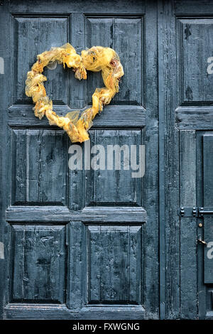 Heart shaped wreath on a wooden front door Stock Photo