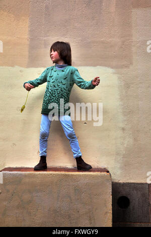 Seven year old boy playing with a toy in the centre of Barcelona. Stock Photo
