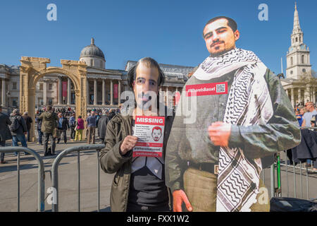 London, UK. 19th April, 2016. A supporter of the Free Bassel campaign - Bassel was one of the original photographers for the preservation project and has been missing since 15 Mar 20112 (see @freebassel or freebasselorg) . Arch of Triumph - A replica of a Syrian monument, two millennia old and destroyed by so-called Islamic State in Syria, has been erected in London's Trafalgar Square. The scale model of the Arch of Triumph has been made from Egyptian marble by the Institute of Digital Archaeology (IDA) using 3D technology, based on photographs of the original arch. Credit:  Guy Bell/Alamy Liv Stock Photo