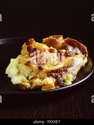 Scoop of bread and butter pudding on plate Stock Photo