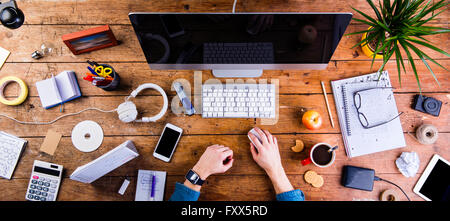 Business person working at office desk wearing smart watch Stock Photo