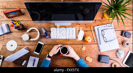 Business person working at office desk wearing smart watch Stock Photo