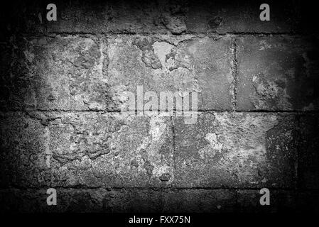 Grey brick wall abstract background. Dark edges. Stock Photo