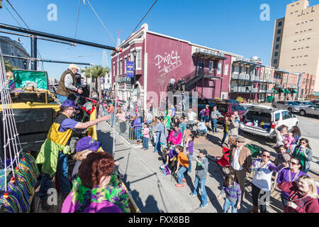 Tossing beads to the crowd from pirate float during the children's parade of the family friendly Mardi Gras in Lake Charles, LA. Stock Photo