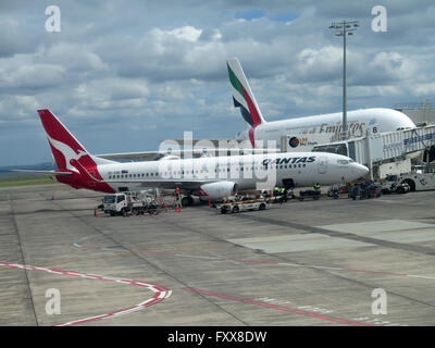 Quantas 737-838 Aircraft at Auckland Airport, with an Emirates Airbus A380 in the background. Stock Photo
