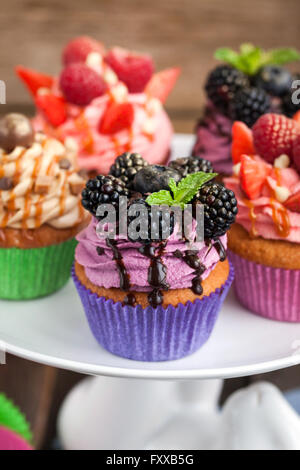 Set of different delicious cupcakes on funny cake-stand Stock Photo