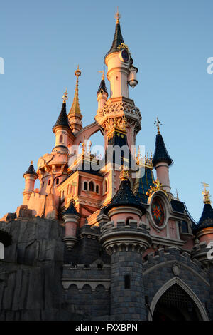 The sleeping beauty castle sun setting in Disneyland Paris France Stock Photo