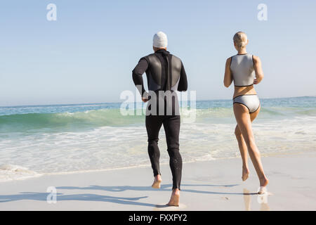 Cute couple running to go in the water Stock Photo