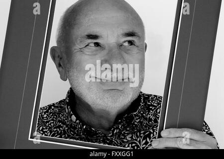 A cranky old man framed in black and white. Stock Photo