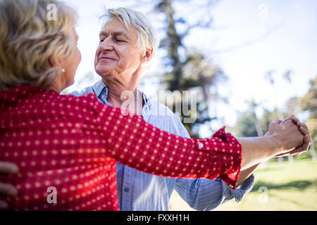 Happy senior couple dancing in the park Stock Photo