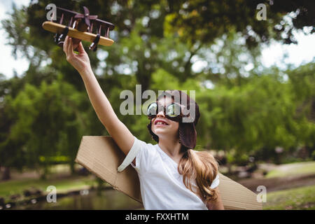 Girl playing with a toy aeroplane Stock Photo