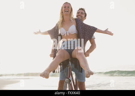 Cute couple having fun on bicycle Stock Photo