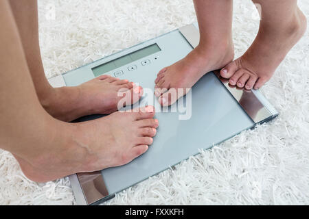 Woman hugging weight scale hi-res stock photography and images - Alamy