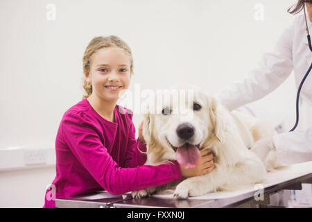 blonde girl smiling with dog Labrador. Labrador lying next Stock Photo ...