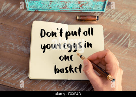 Handwritten quote Don't put all your eggs in one basket as inspirational concept image Stock Photo