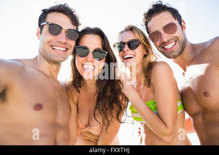 Portrait of smiling friends on the beach Stock Photo