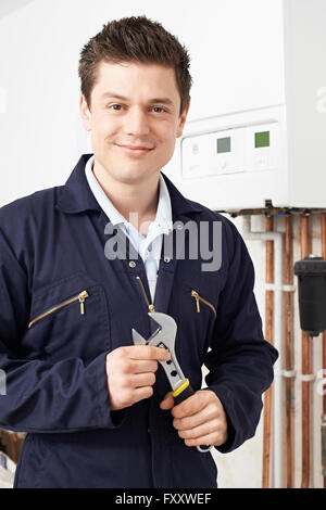Male Plumber Working On Central Heating Boiler Stock Photo