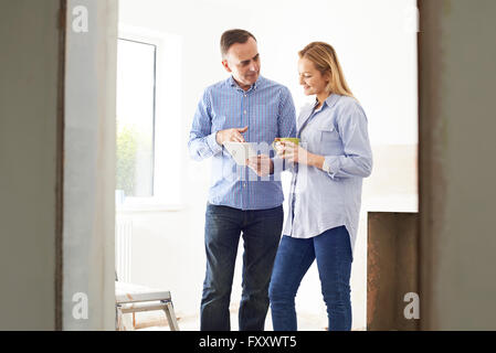 Woman Meeting With Architect Or Builder In Rennovated Property Stock Photo